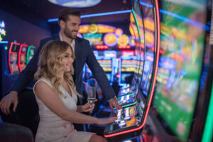 handsome couple having fun and drinking wine at casino